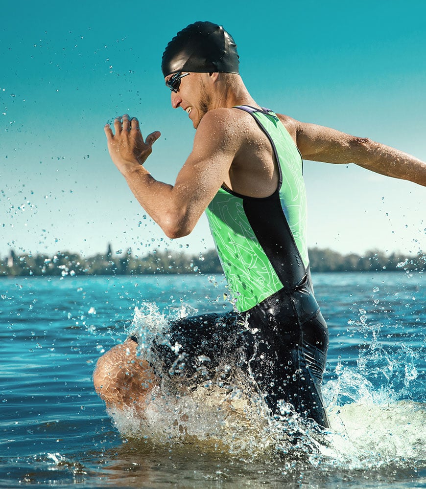 Male athlete running through water