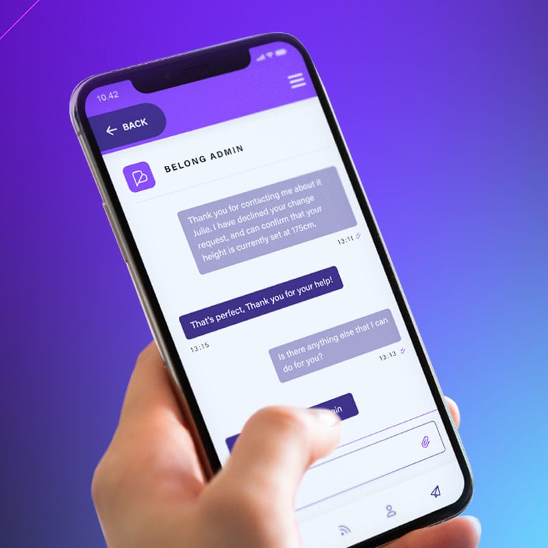 An iPhone with a chat open within Belong, a player management and engagement app