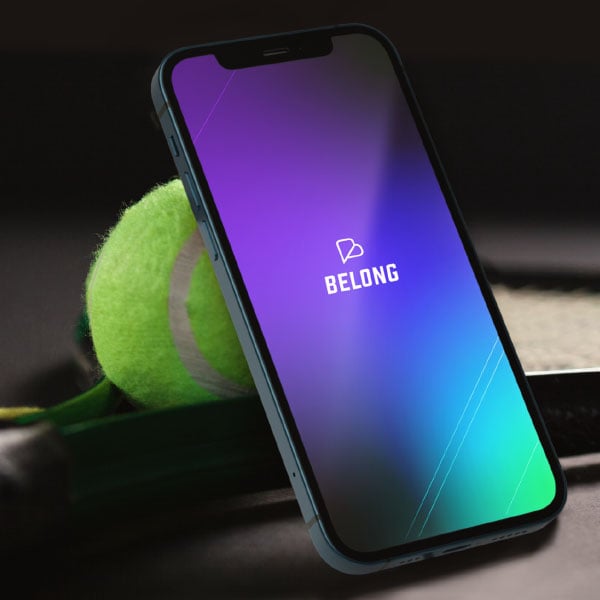 Decorative image showing the Belong splash screen on an iPhone in a tennis environment
